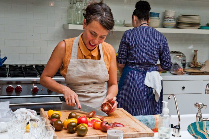 Two cooks preparing a dinner in a bright kitchen