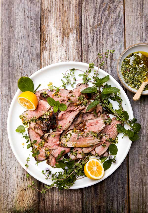 Sliced lamb with fresh herbs and lemon