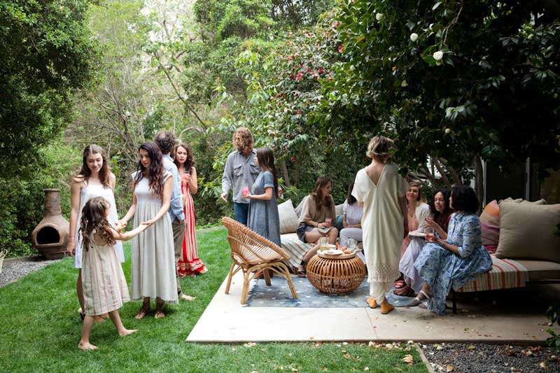 Guests gathered for a party in a leafy garden