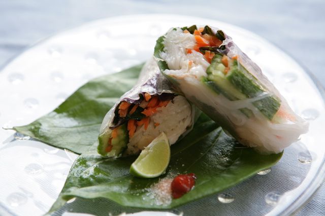 Summer rolls on a banana leaf with lime