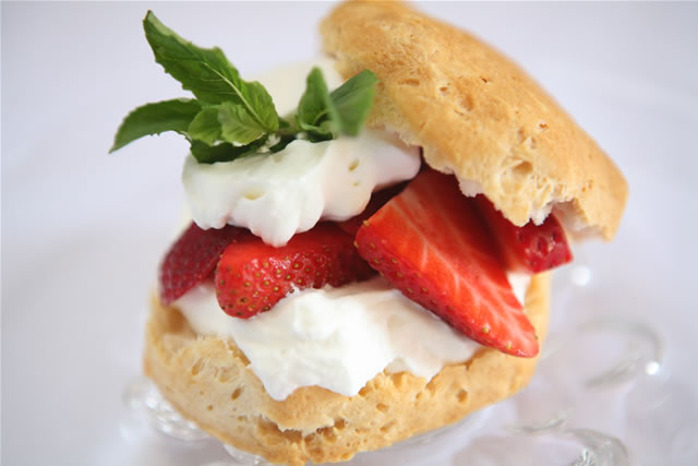 Strawberry shortcake with whipped cream and basil