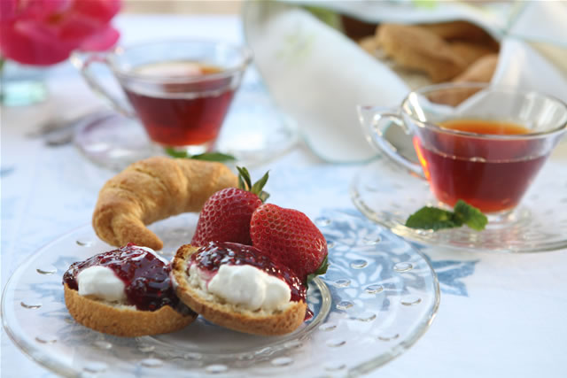 Tea service with berries and pastries